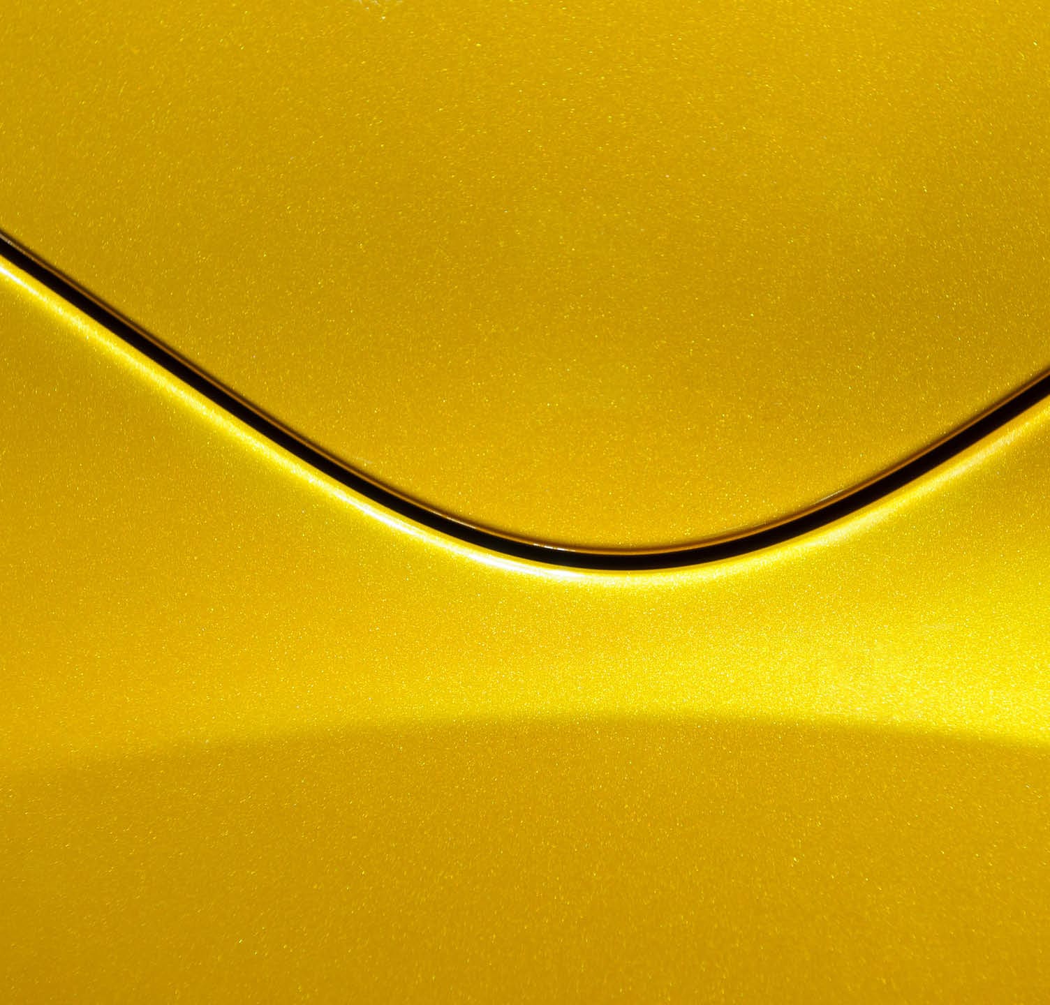 Smooth curves of bright yellow metal car body. Abstract - steel post envelope.
