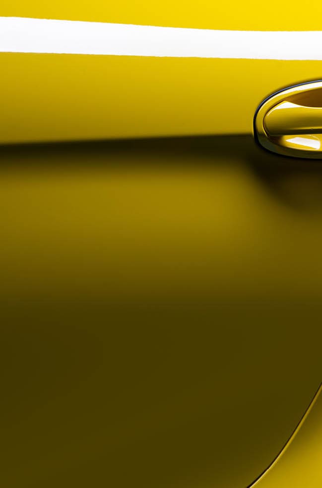 Car detailing series: Closeup of clean yellow sports car €™s door