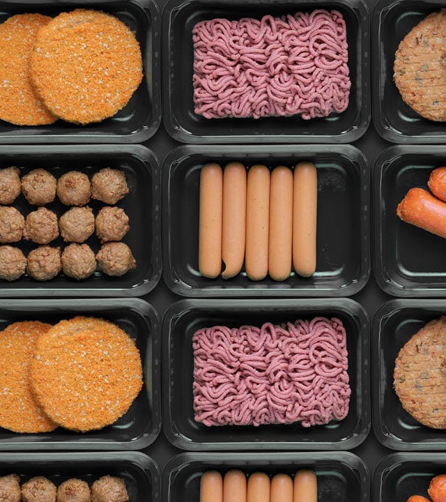 pattern of green trays with vegetarian meat substitute products, plant based mock meat