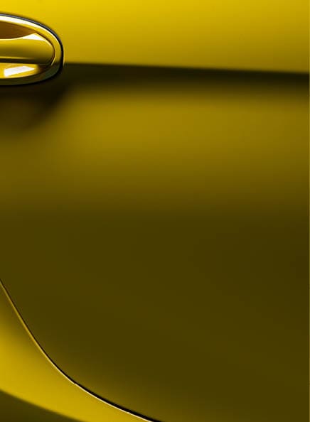 Car detailing series: Closeup of clean yellow sports car €™s door
