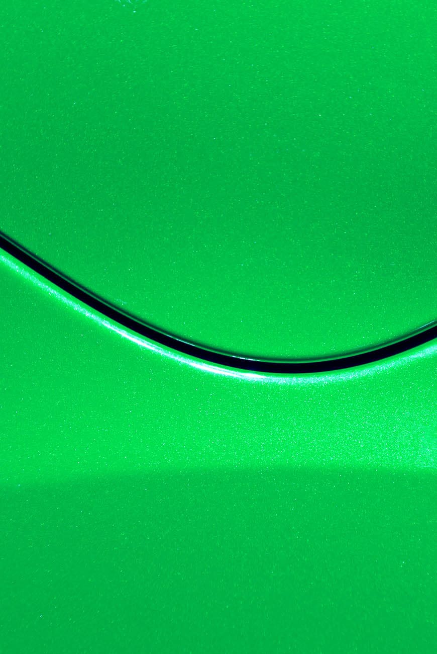 Smooth curves of bright yellow metal car body. Abstract - steel post envelope.